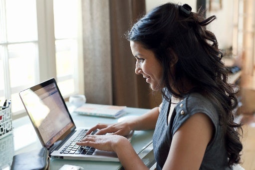 Woman smiling at her laptop