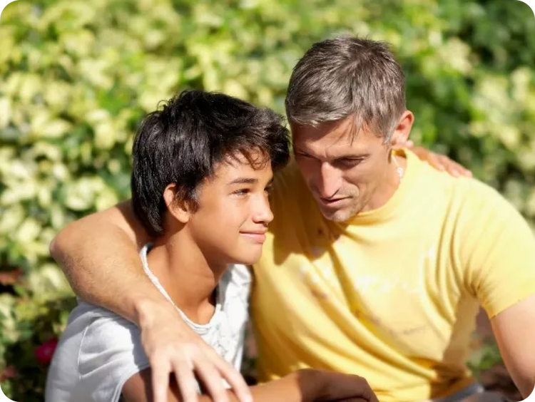 A dad with his arm around his son