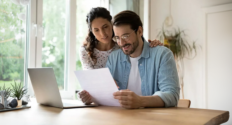 Man and woman reading a document together