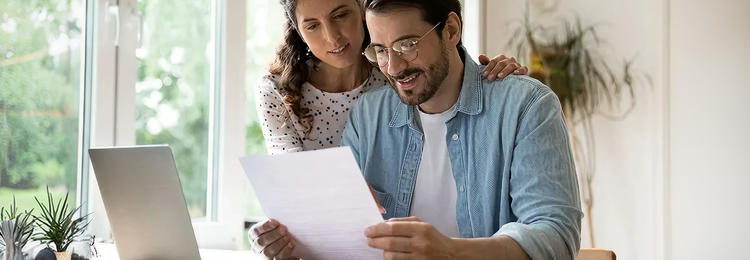 Man and woman reading a document together